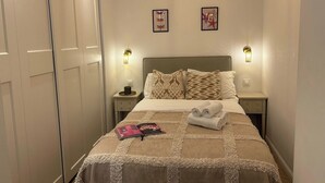 1 bedroom, desk, iron/ironing board, travel crib