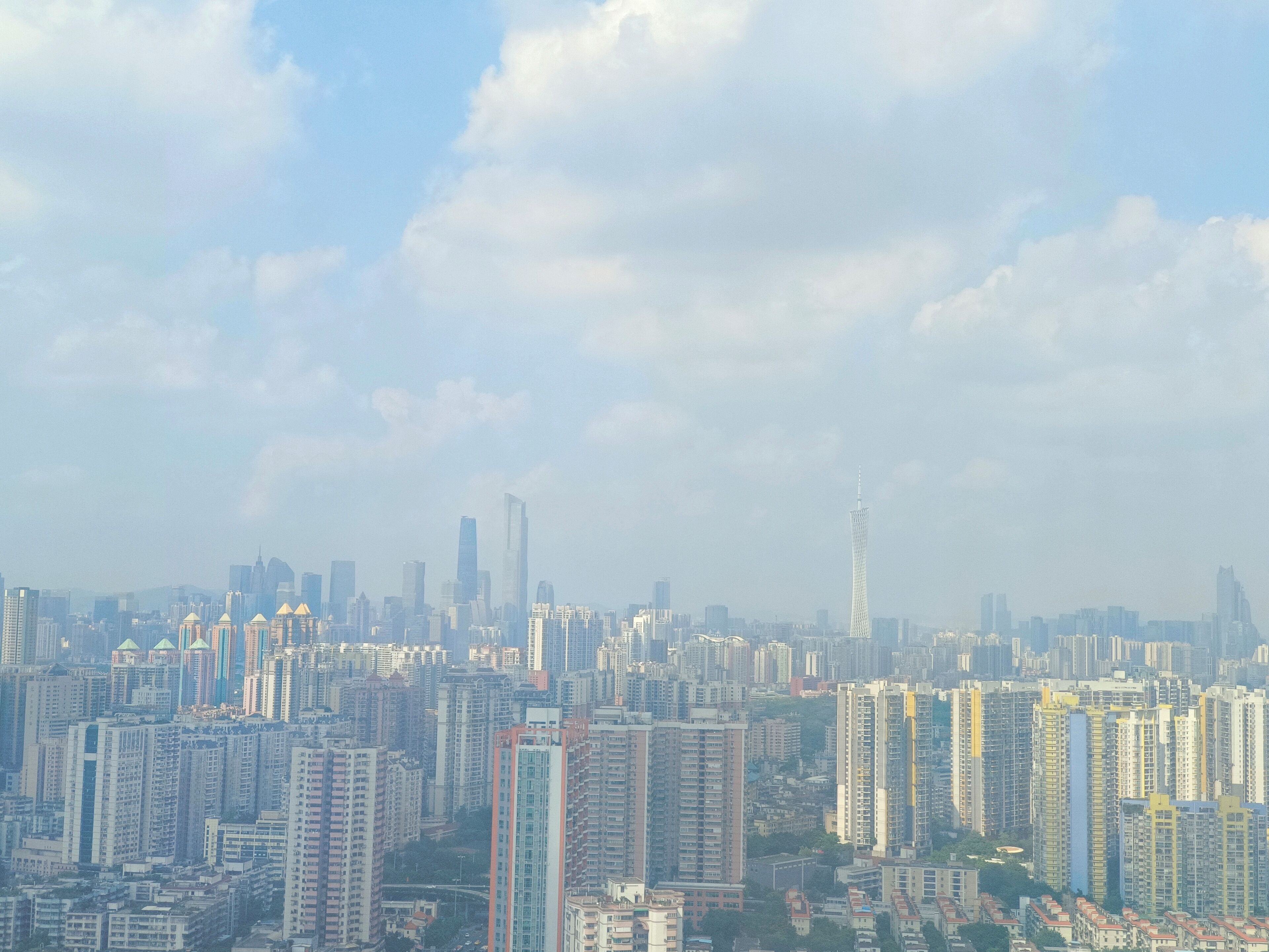 A high-rise urban area with dense skyscrapers and a prominent tower.
