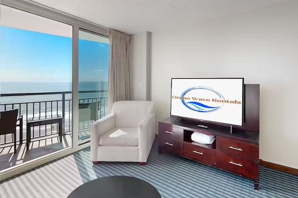 Bright living room with ocean view and balcony access