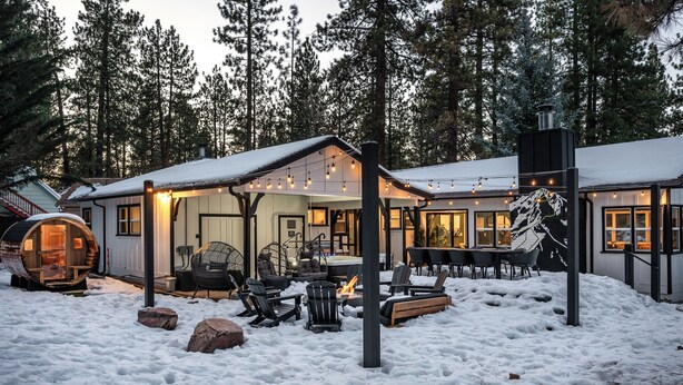 A cozy cabin with a fire pit, outdoor seating, and a snow-covered landscape. - Summit Haven - Spa - Sauna - Gameroom - 1/4 acre backyard fenced-in (Big Bear Lake)
