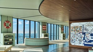 A spacious room with large windows, a curved wooden ceiling, and a map of Tokyo on the wall. - OMO5 Yokohama Bashamichi by Hoshino Resorts (Yokohama)