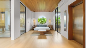 A modern bedroom with a wooden ceiling, a circular skylight, a bed, bedside tables, and a large window. - Dago Escape Villa by Kozystay - Bandung (Cimenyan)