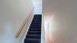 A staircase with carpeted steps and wooden handrails, leading to an upper floor. - Natural, quiet, central home for your easy & comfortable trip to Frankston. (Frankston)