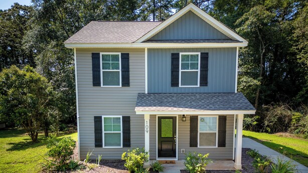 A two-story house with a front porch, a garage, and a well-maintained lawn. - Clemson Weekend Rental- very close to campus, 4 Bedroom 3 Bathroom (Clemson)