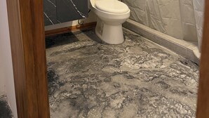 A bathroom with a toilet, a vanity with a marble countertop, a mirror, and a shower curtain. - Hosteria 7 in the heart of the historic center! (Zacatecas)