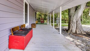 A covered porch with a bench and a red box. - No Pet Fee! Peaceful Escape at Towner Properties (Langston)