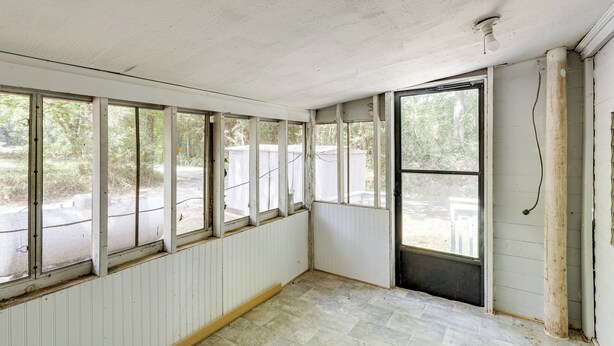 A room with large windows, white walls, and a tiled floor. - No Pet Fee! Peaceful Escape at Towner Properties (Langston)