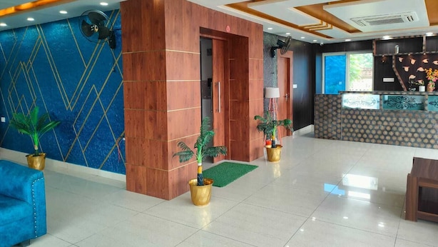 Een moderne lobby met een receptiebalie, houten details en potplanten.