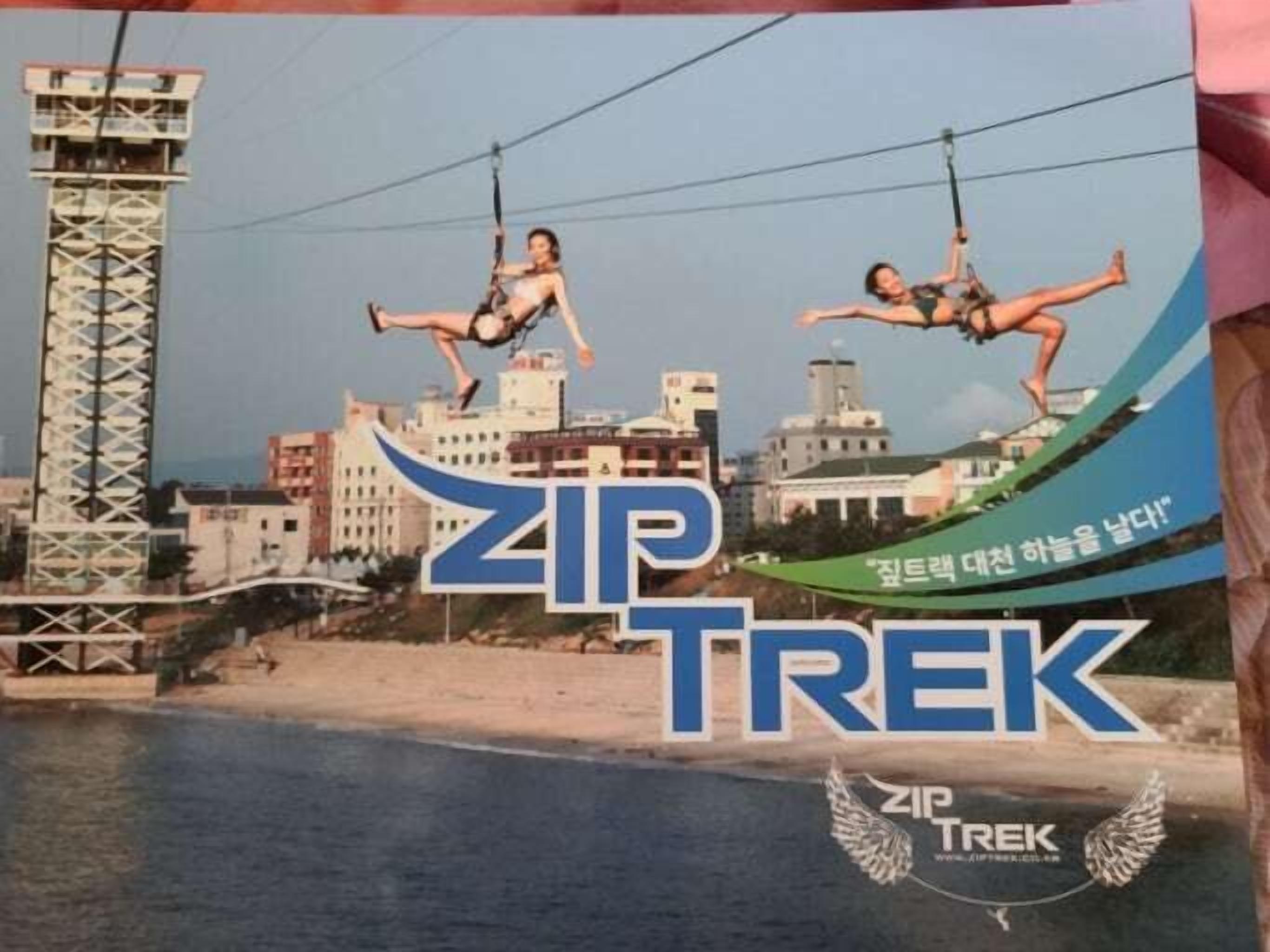 A poster with the text "ZIP TREK" and a cityscape in the background.