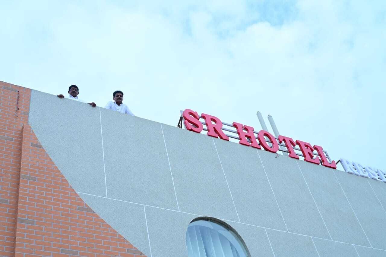 A hotel sign with the name "SR HOTEL" in large letters.