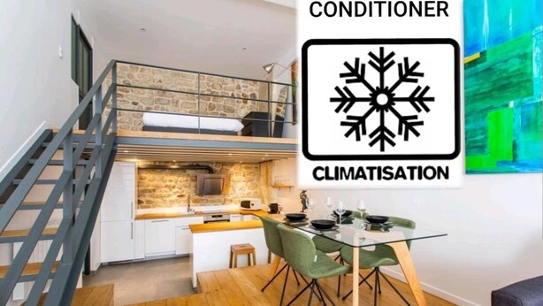A modern kitchen with a stone backsplash, a dining area with a glass table, and a staircase.