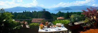 Penthouse with terrace overlooking lake, mountains and stars