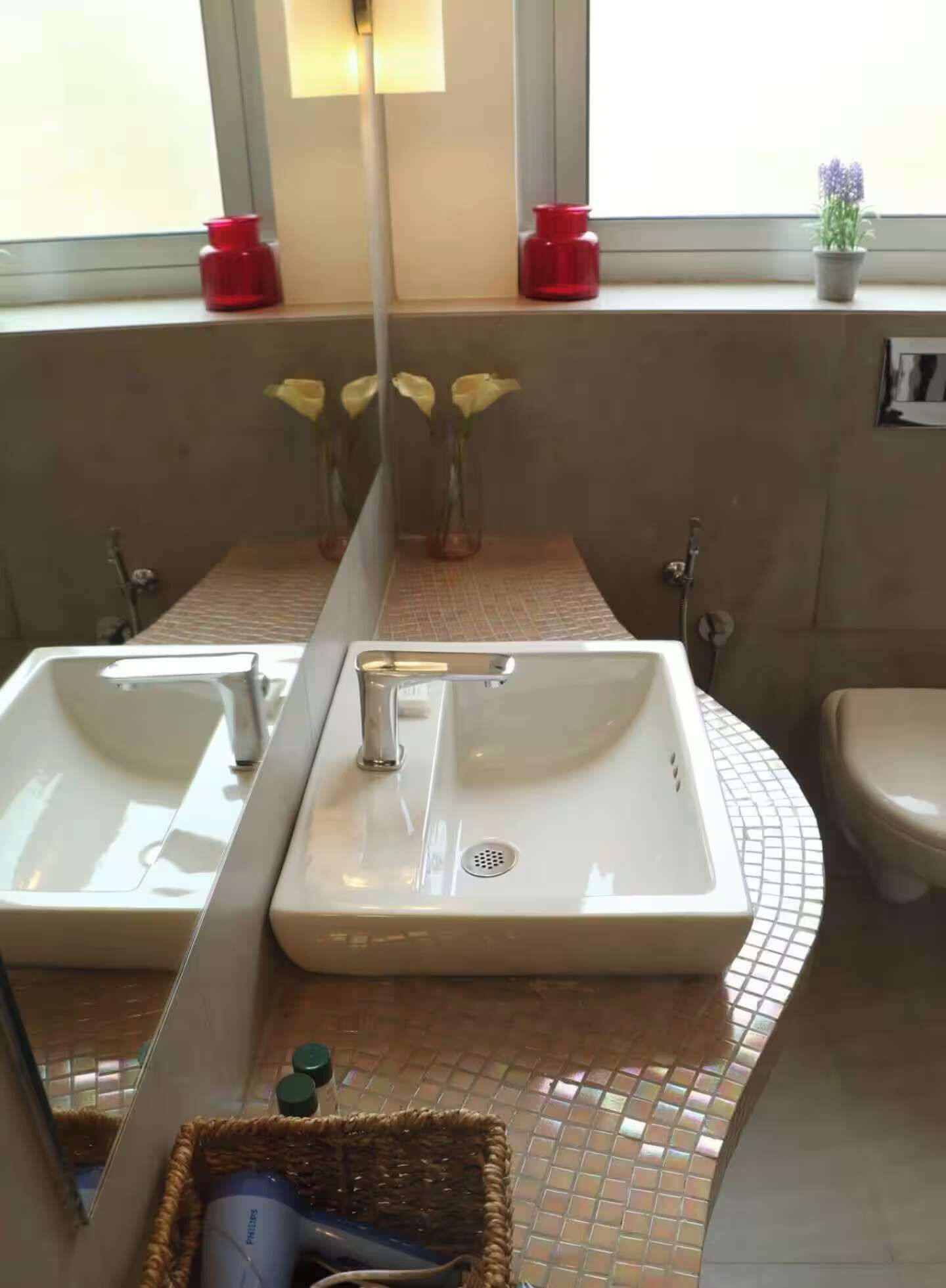 A bathroom with two sinks, a mirror, and a window with a view.