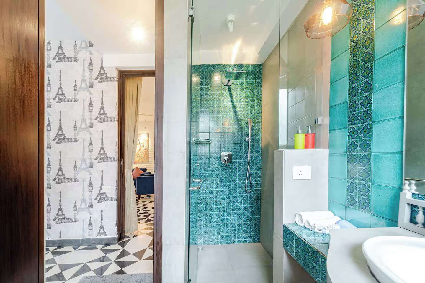 A modern bathroom with a shower, a sink, and a mirror.