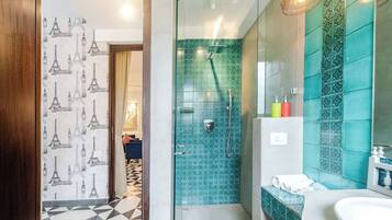 A modern bathroom with a shower, a sink, and a mirror.