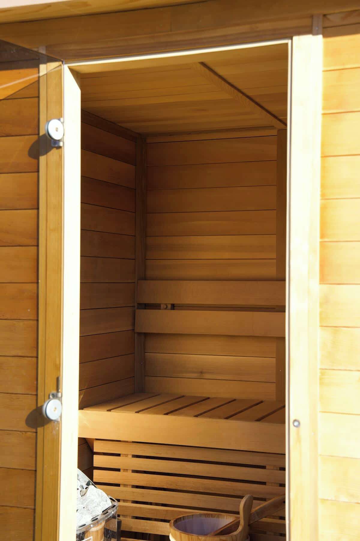 A sauna with wooden walls and benches.
