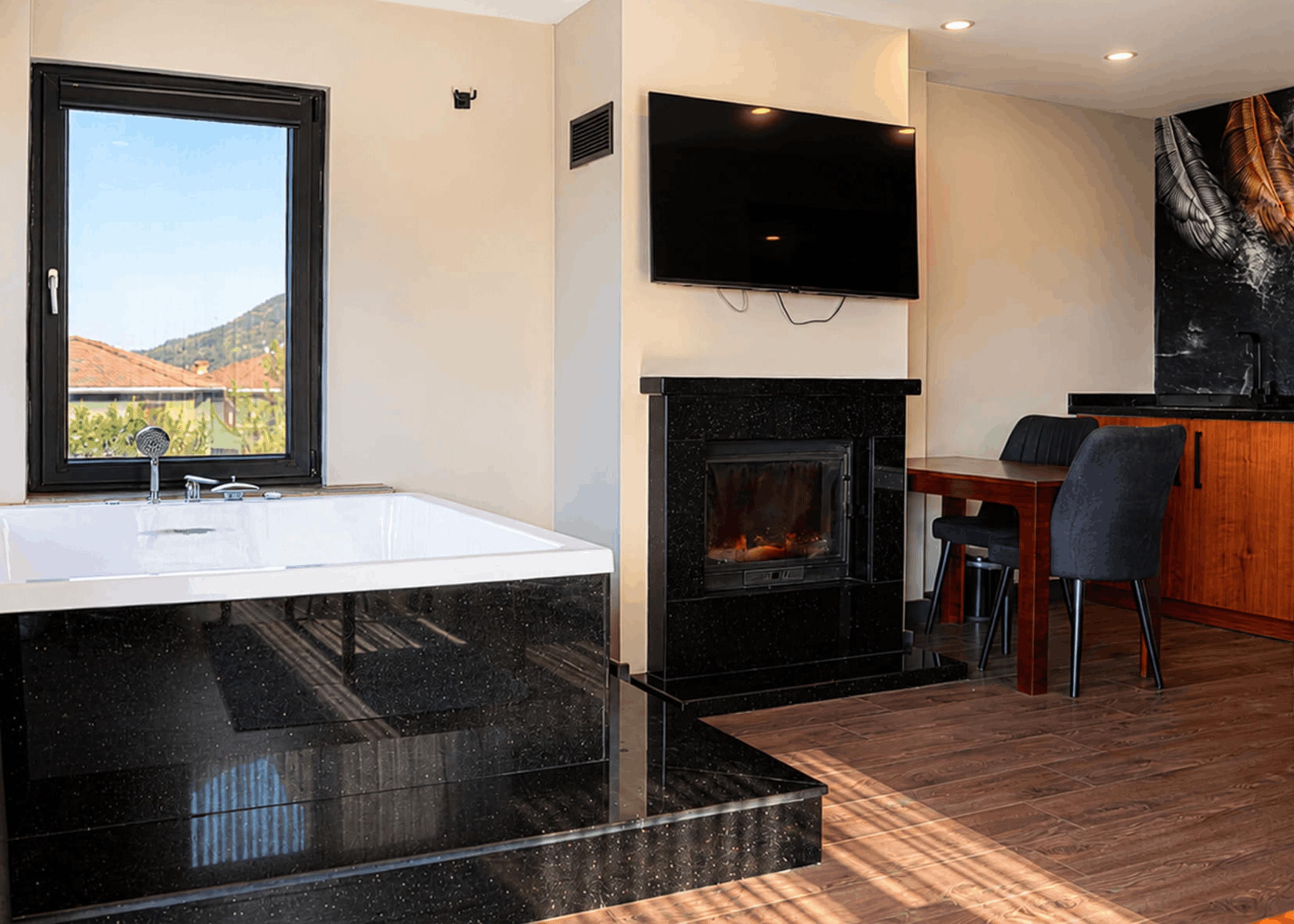 Un baño moderno con una bañera grande, una chimenea y un comedor con una mesa y sillas.
