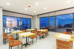 A modern dining area with tables and chairs, large windows with city views, and a clean, contemporary design. - Best Western Plus Sapanca (Sapanca)