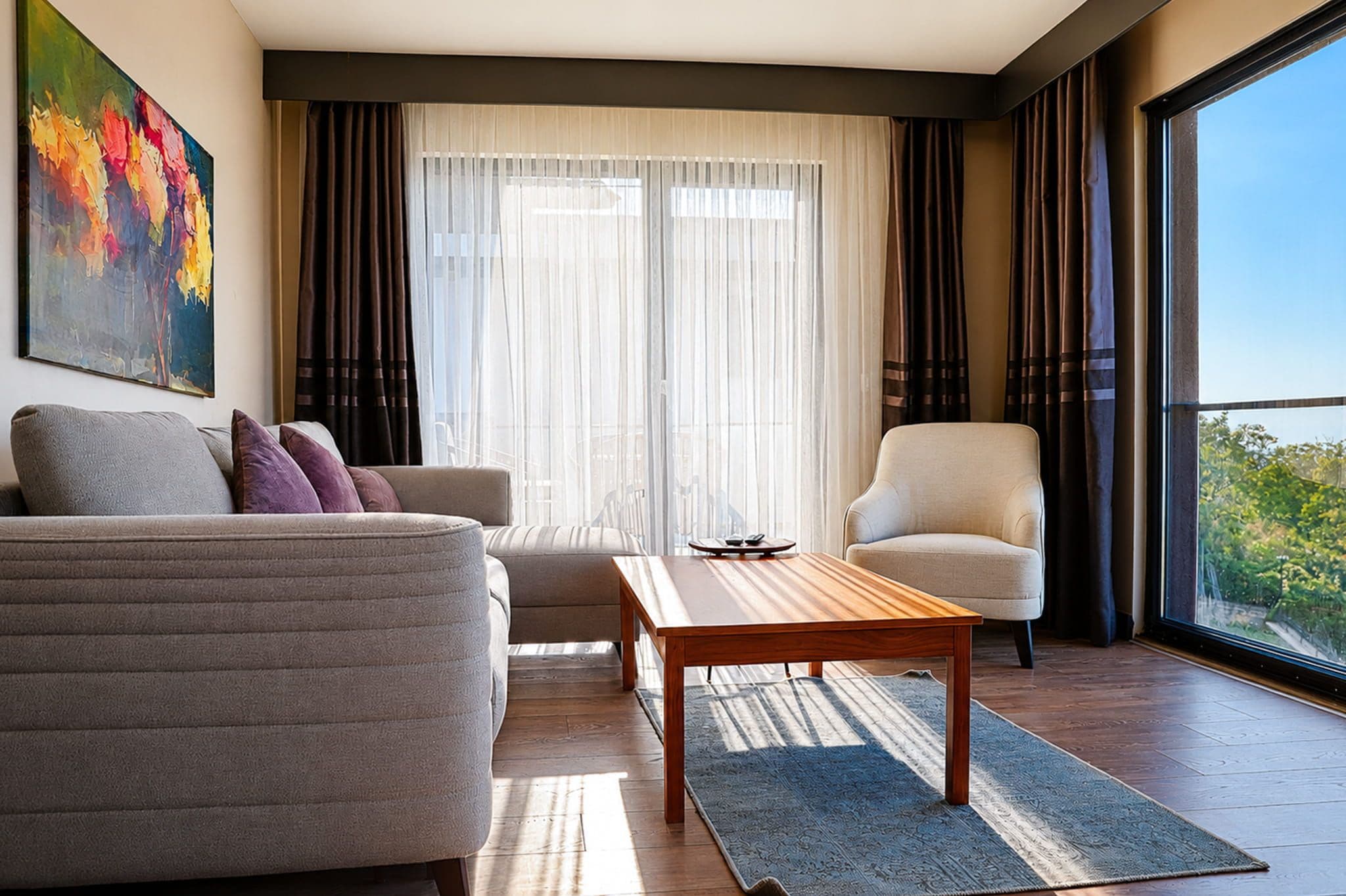 A modern living room with a sofa, armchair, and coffee table.