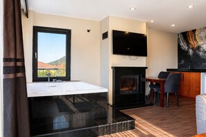 A modern bathroom with a large mirror, a bathtub, and a fireplace. - Best Western Plus Sapanca (Sapanca)