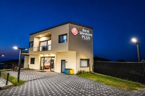 A modern hotel with a sign reading 'Best Western PLUS.' It features a two-story structure with a flat roof, a visible entrance, and a paved walkway leading to the entrance. - Best Western Plus Sapanca (Sapanca)