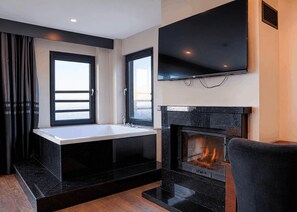 A modern bathroom with a bathtub, a sink, and a fireplace. - Best Western Plus Sapanca (Sapanca)