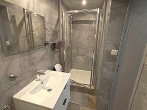 Shower, hair dryer, soap, toilet paper