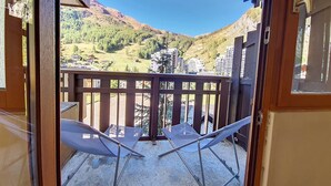 A balcony with a view of a mountainous landscape.