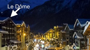 A snow-covered village with traditional chalet-style buildings and a prominent hotel named "Le Dome" highlighted. - Comfortable studio in center, balcony, 2-3 pers. (Val-d'Isère)