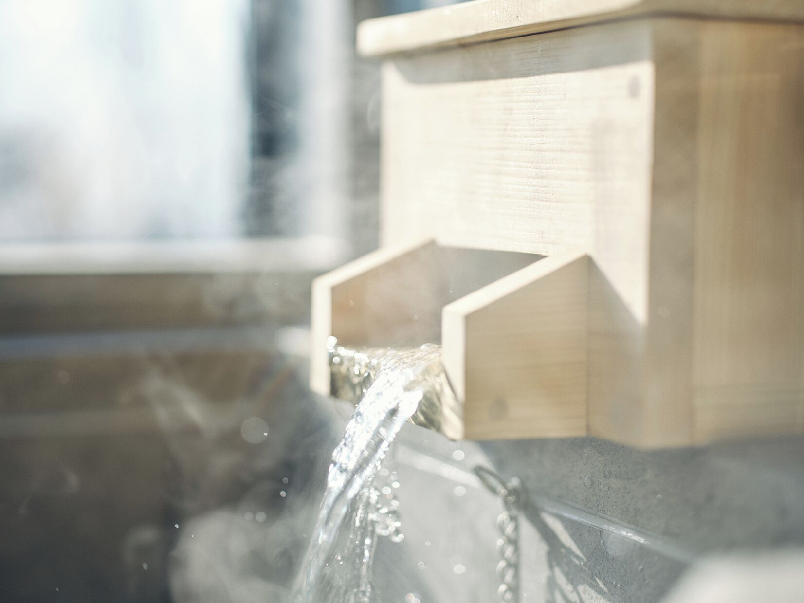 A wooden structure with a water spout.