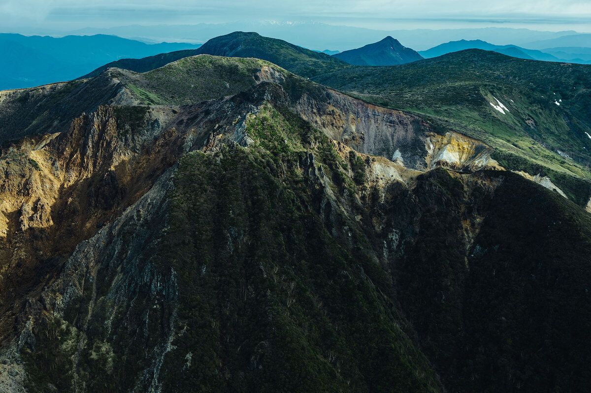 A mountainous landscape with rugged terrain and sparse vegetation.