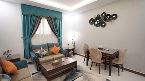 55-inch Smart TV with cable channels, Netflix, smart speakers - Seasons hotel suites (Al Kharj)