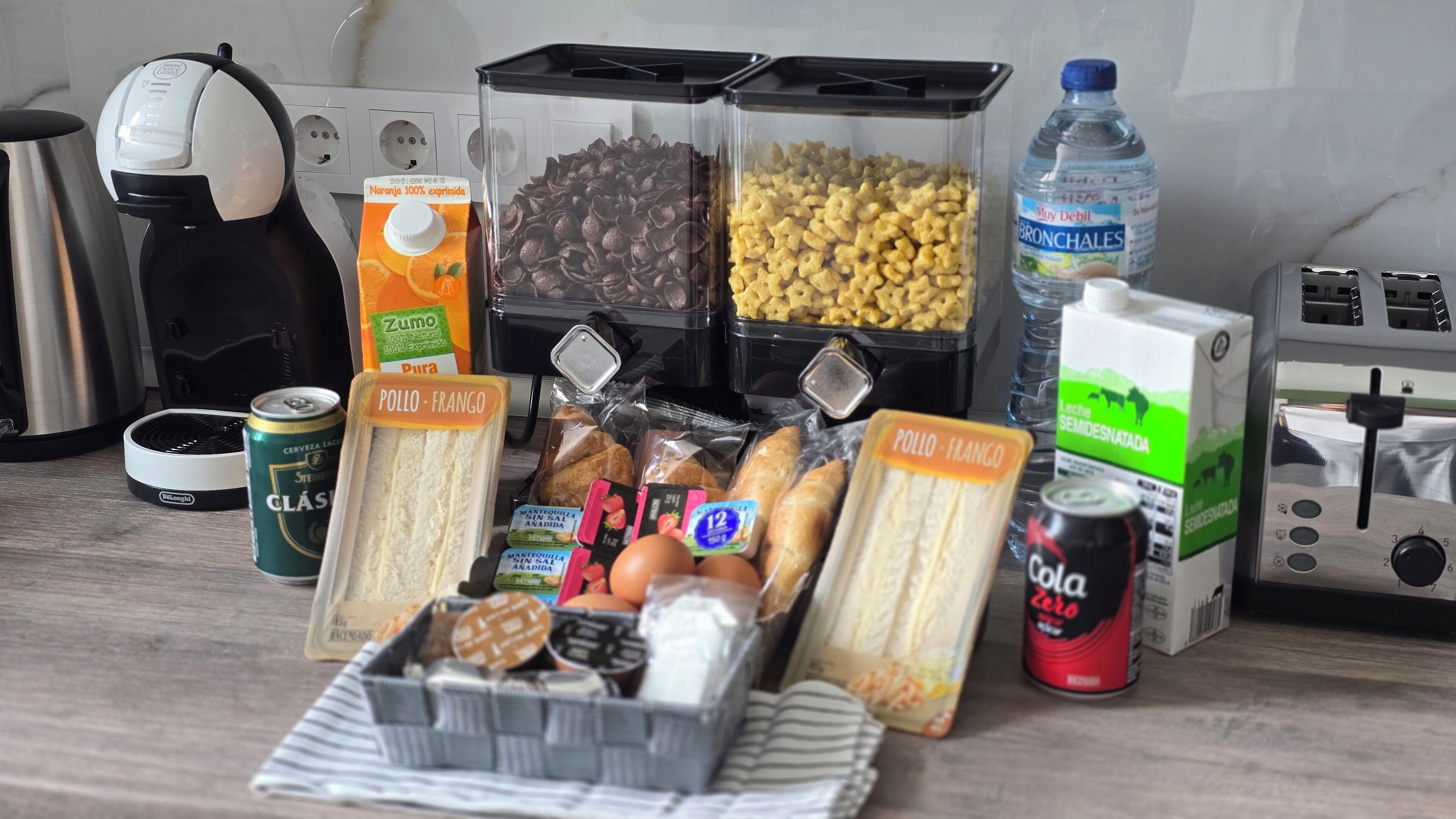 A kitchen counter with various food items and kitchen appliances.
