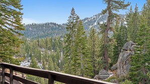 A forested mountain landscape with a wooden viewing platform. - Tramway Treat | Ski Heavenly | Mountain Views (Stateline)