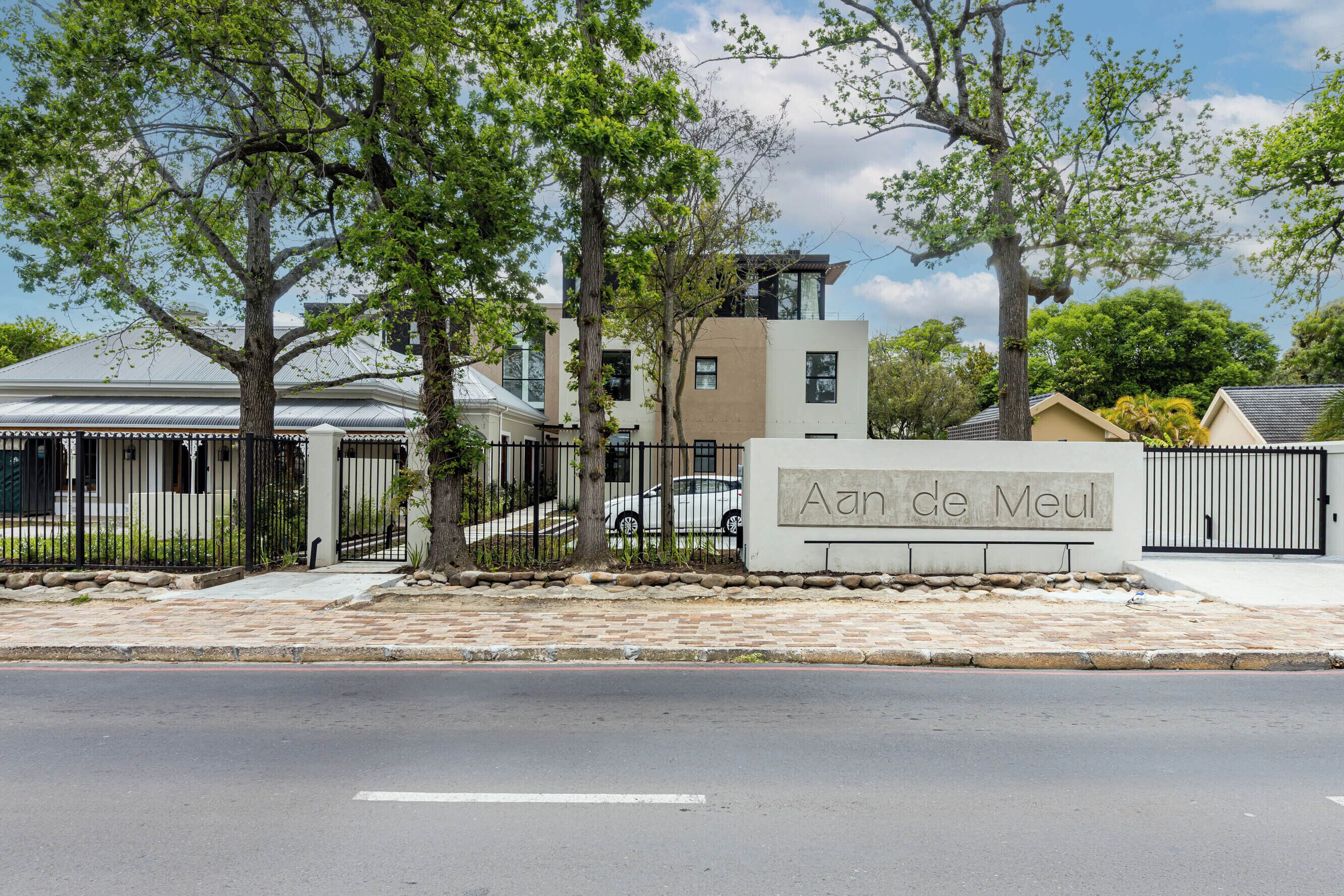A gated residential area with a sign reading "Aan de Meul".