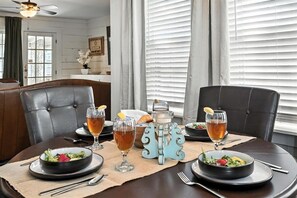 A dining table set with plates, glasses, and a decorative centerpiece. - Big House on Highland: Your Country Escape (Abilene)