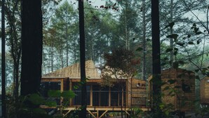 A cabin in a forest with a wooden deck and a small porch. - SANU 2nd Home Yatsugatake 3rd (Hokuto)