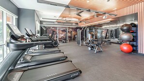 A gym with treadmills, weight machines, and exercise balls. - Regards At Med Center 130 I Spacious 1 Bed 1 Bath (Houston)