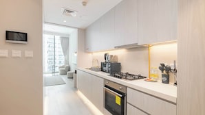 A modern kitchen with a built-in oven, a gas stove, and a toaster.