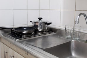 Fridge, stovetop, cookware/dishes/utensils, dining tables