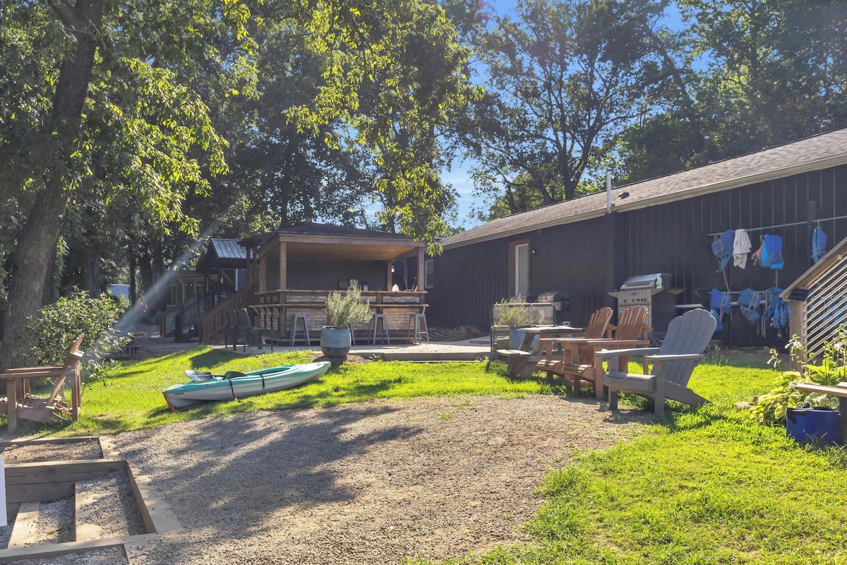A backyard with a barbecue area, outdoor seating, and a boat.