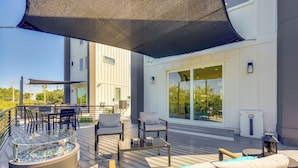 A deck with outdoor furniture, a fire feature, and a large window. - Walk to Dtwn Shops & Eats: St Augustine Haven! (St. Augustine)