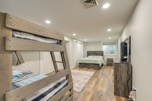 A bedroom with a bunk bed, a desk, a dresser, and a window with blinds. - Waterfront Haven Bi-level Lakefront Deck/game Cntr (Fort Ann)