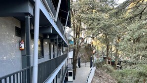 A building with a balcony, a fire extinguisher, and a pathway leading to a gate. - goSTOPS Mussoorie Clock Tower (Mussoorie)