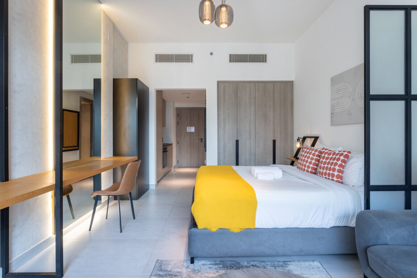 Ein modernes Hotelzimmer mit Bett, Schreibtisch und einer Sitzecke.