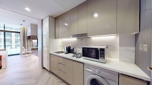 A modern kitchen with a built-in microwave, stove, and dishwasher.
