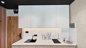 A modern kitchen with a central island, built-in cabinets, and under-cabinet lighting.