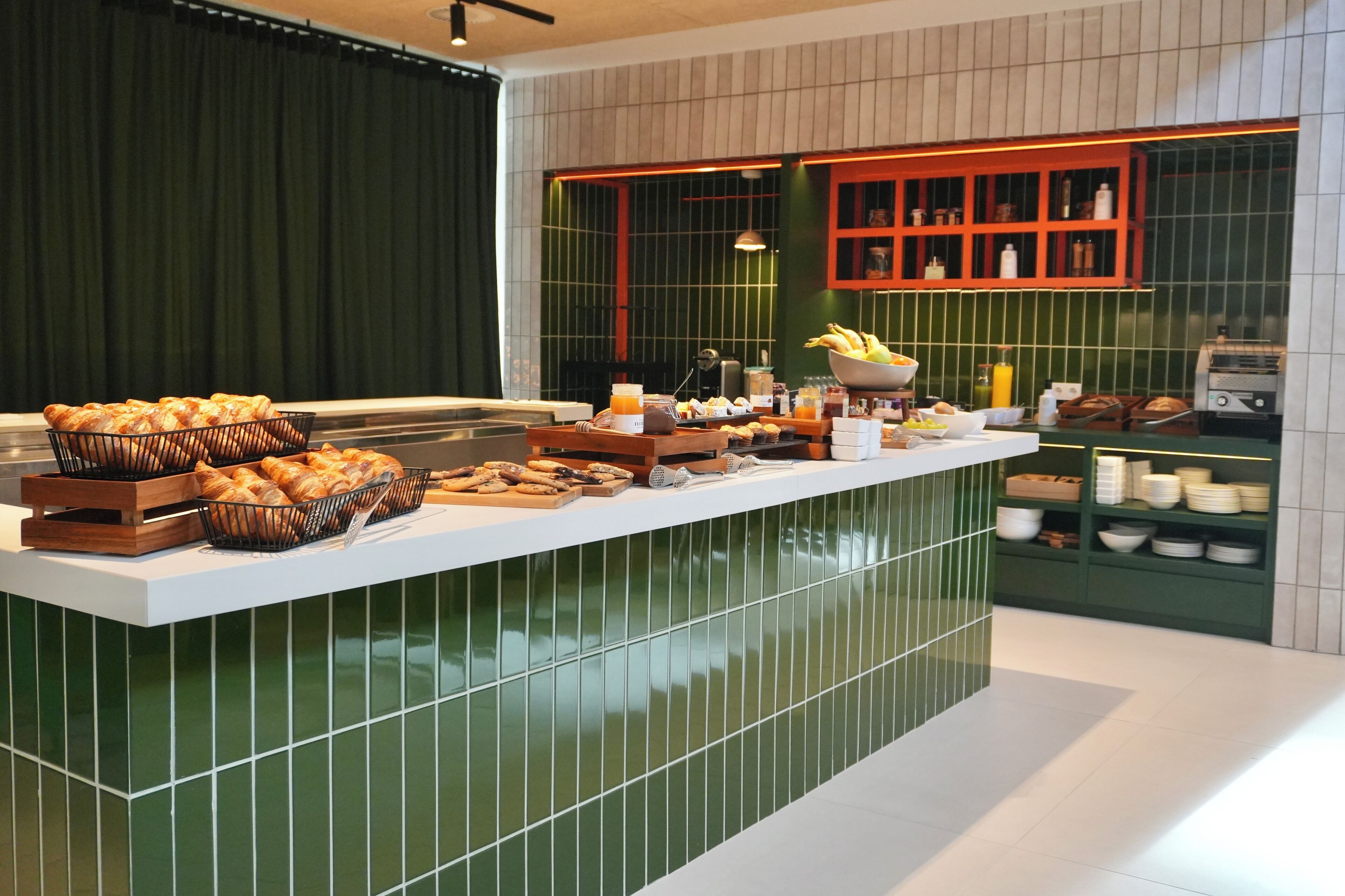 A buffet setup with various food items and a toaster.