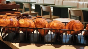 A bakery display with pastries in a cafe setting. - KORA KILIKI (Pamplona)
