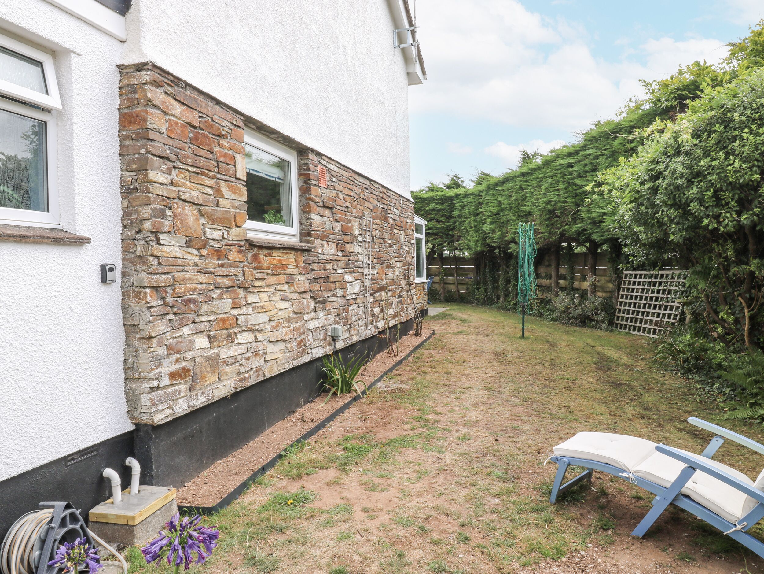 A house with a stone exterior and a garden.